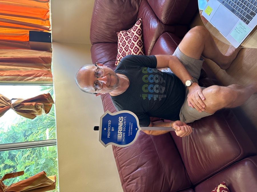 Homeowner with Brinks Home security yard sign