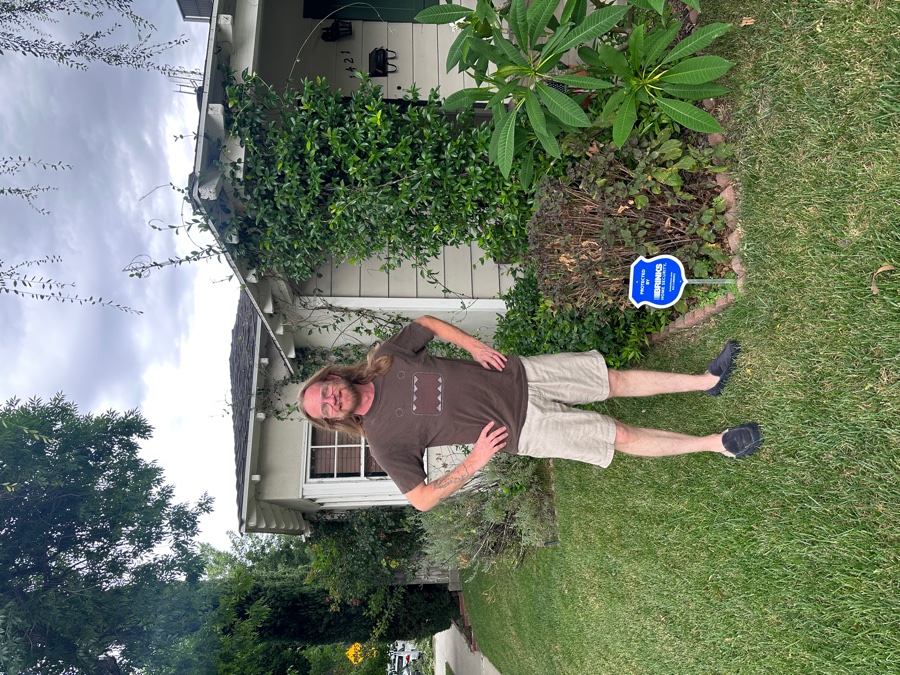 Homeowner with Brinks Home security yard sign
